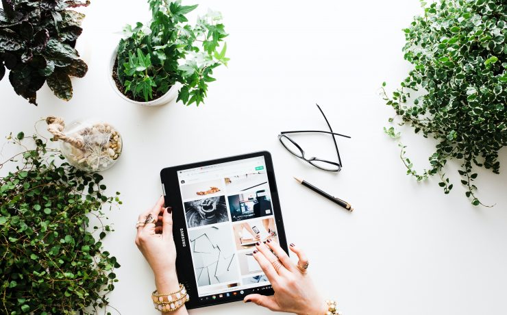 hands-scrolling-social-media-on-a-tablet