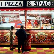 boys-eating-pizza-outside-a-pizza-shop