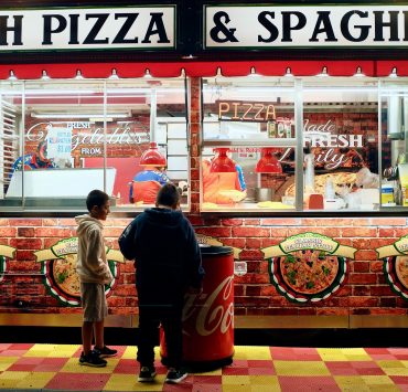 boys-eating-pizza-outside-a-pizza-shop